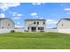 The backyard has a well-kept lawn and white fences bordering the neighboring properties at 73 Windswept Way, Fuquay Varina, NC 27526