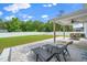 Covered backyard patio with outdoor seating and a lush green lawn at 73 Windswept Way, Fuquay Varina, NC 27526
