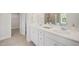 Bathroom featuring double vanity, mirrors, modern fixtures, and open doorway at 73 Windswept Way, Fuquay Varina, NC 27526