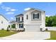 Two-story home features a two-car garage, white siding and black shutters and a manicured lawn at 73 Windswept Way, Fuquay Varina, NC 27526