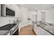 Modern kitchen featuring stainless steel appliances, stylish backsplash and gray countertops at 73 Windswept Way, Fuquay Varina, NC 27526