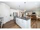 Modern kitchen island featuring granite countertops and stylish white cabinetry at 73 Windswept Way, Fuquay Varina, NC 27526