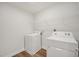 Efficient laundry area with modern white washer and dryer, ensuring convenience and functionality for homeowners at 73 Windswept Way, Fuquay Varina, NC 27526