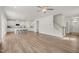 Bright living room featuring an open floor plan, hardwood floors and staircase leading to upper level at 73 Windswept Way, Fuquay Varina, NC 27526