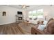 Comfortable living room with a stone fireplace, plush sofas, and stylish decor for cozy gatherings at 73 Windswept Way, Fuquay Varina, NC 27526