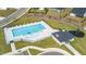 Aerial view of a community pool with lounge chairs and a nearby playground area at 73 Windswept Way, Fuquay Varina, NC 27526