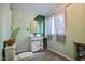 A charming bathroom with banana leaf themed wall, a modern vanity, and ample natural light at 82 Deercorn Path, Moncure, NC 27559