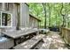 Outdoor dining and lounge area on a wooden deck, featuring a built-in hot tub at 82 Deercorn Path, Moncure, NC 27559