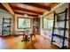 An airy dining room with wood floors, exposed beams, and abundant natural light, creating a warm and inviting space at 82 Deercorn Path, Moncure, NC 27559