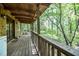 Covered wooden porch overlooking the wooded property at 82 Deercorn Path, Moncure, NC 27559