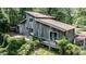 Rustic two-story home featuring a wooden exterior and a partially covered deck at 82 Deercorn Path, Moncure, NC 27559