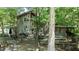 Charming wood-sided home featuring a large wooden deck and mature trees at 82 Deercorn Path, Moncure, NC 27559