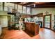 A rustic kitchen featuring wooden cabinets, bar, and a spiral staircase, exuding a cozy and unique charm at 82 Deercorn Path, Moncure, NC 27559