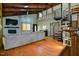 Open living space with hardwood floors, exposed beam ceiling, spiral staircase and fireplace at 82 Deercorn Path, Moncure, NC 27559