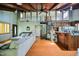 Open living area with exposed beam ceiling, spiral staircase and hardwood floors at 82 Deercorn Path, Moncure, NC 27559