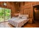 A cozy main bedroom with wood paneling, offering a private balcony and comfortable seating, perfect for unwinding at 82 Deercorn Path, Moncure, NC 27559