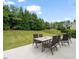 Backyard featuring a patio with a table set, manicured lawn, and fenced perimeter at 901 Lemongrass Ln, Wake Forest, NC 27587