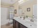 Bathroom featuring dual sinks, dark cabinetry, and shower-tub combination at 901 Lemongrass Ln, Wake Forest, NC 27587