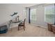 Bright bedroom featuring neutral walls, two windows, and a desk with a chair at 901 Lemongrass Ln, Wake Forest, NC 27587