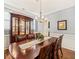 Elegant dining room with a large wooden table, china cabinet, and stylish chandelier at 901 Lemongrass Ln, Wake Forest, NC 27587