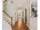 Open foyer with hardwood flooring, neutral paint, and archway to kitchen at 901 Lemongrass Ln, Wake Forest, NC 27587
