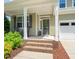 Inviting front exterior showcasing a charming porch, well-kept lawn, and neutral color palette at 901 Lemongrass Ln, Wake Forest, NC 27587