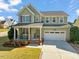 Charming two-story home with a well-manicured lawn, covered porch, and two-car garage at 901 Lemongrass Ln, Wake Forest, NC 27587