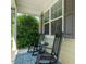 Relaxing front porch featuring classic rocking chairs and a decorative rug, perfect for enjoying the outdoors at 901 Lemongrass Ln, Wake Forest, NC 27587