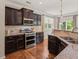 Gourmet kitchen featuring stainless steel appliances, granite countertops, and dark cabinetry at 901 Lemongrass Ln, Wake Forest, NC 27587