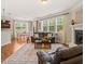 Bright living room with a cozy fireplace, hardwood floors, and large windows at 901 Lemongrass Ln, Wake Forest, NC 27587