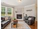 Comfortable living room with hardwood floors, a fireplace, and plenty of natural light at 901 Lemongrass Ln, Wake Forest, NC 27587