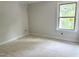 Neutral-toned bedroom with a large window to allow natural light to enter at 901 Linwood Ave, Durham, NC 27701