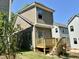 Rear view of a craftsman home featuring a wooden deck and green lawn at 901 Linwood Ave, Durham, NC 27701
