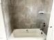 Remodeled bathtub features gray square tiling at 903 Linwood Ave, Durham, NC 27701