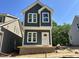 New two-story home featuring gray siding, white trim and large windows on a bright, sunny day at 903 Linwood Ave, Durham, NC 27701