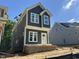 Exterior view of a two-story home featuring gray siding, white trim and ample window light at 903 Linwood Ave, Durham, NC 27701