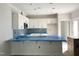 Unfinished kitchen featuring white cabinets and a light blue backsplash at 903 Linwood Ave, Durham, NC 27701