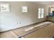 Bright, unfinished living room with large windows allowing ample natural light at 903 Linwood Ave, Durham, NC 27701