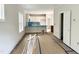 Spacious, unfinished living room leading into the kitchen with white cabinets at 903 Linwood Ave, Durham, NC 27701