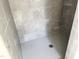 New shower with gray, square tiling and herringbone patterned flooring at 903 Linwood Ave, Durham, NC 27701