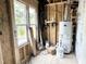 New utility room featuring a water heater and natural light at 903 Linwood Ave, Durham, NC 27701