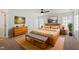 Cozy bedroom showcasing warm wood furniture, artwork, and natural light from multiple windows at 9117 Meadow Mist Ct, Raleigh, NC 27617