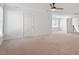 Bright bedroom with neutral carpet, ceiling fan, and natural light coming from the exterior windows at 9117 Meadow Mist Ct, Raleigh, NC 27617