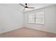 Cozy bedroom with a ceiling fan, neutral walls, and carpet, with a window providing natural light at 9117 Meadow Mist Ct, Raleigh, NC 27617