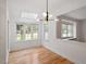 Sunlit breakfast nook with hardwood floors, and a modern light fixture at 9117 Meadow Mist Ct, Raleigh, NC 27617