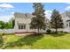 Home's exterior showcasing a well-manicured lawn and mature trees at 9117 Meadow Mist Ct, Raleigh, NC 27617