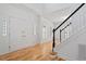 Bright foyer with hardwood floors, white walls, staircase with black railing, and natural light at 9117 Meadow Mist Ct, Raleigh, NC 27617