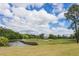 Scenic view of the golf course with a tranquil pond and lush greenery at 9117 Meadow Mist Ct, Raleigh, NC 27617