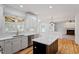 Bright kitchen featuring a center island, stainless steel appliances, white cabinets, and plenty of counter space at 9117 Meadow Mist Ct, Raleigh, NC 27617
