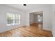 Bright living room featuring hardwood floors, white wainscoting, ample natural light, and neutral colors at 9117 Meadow Mist Ct, Raleigh, NC 27617